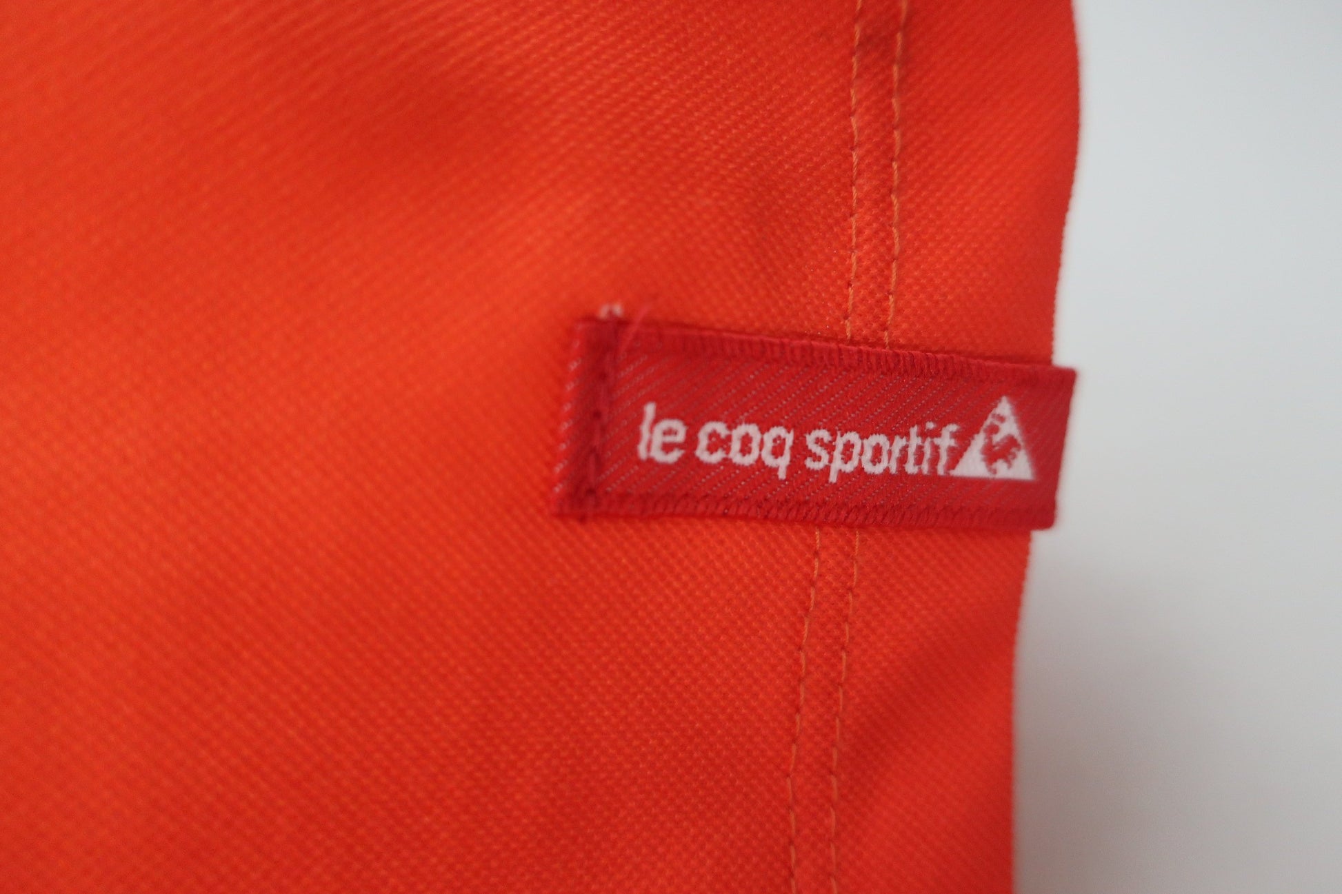 le coq sportif(ルコックスポルティフ) 半袖ハーフジップシャツ 黄色オレンジ レディース L B-8