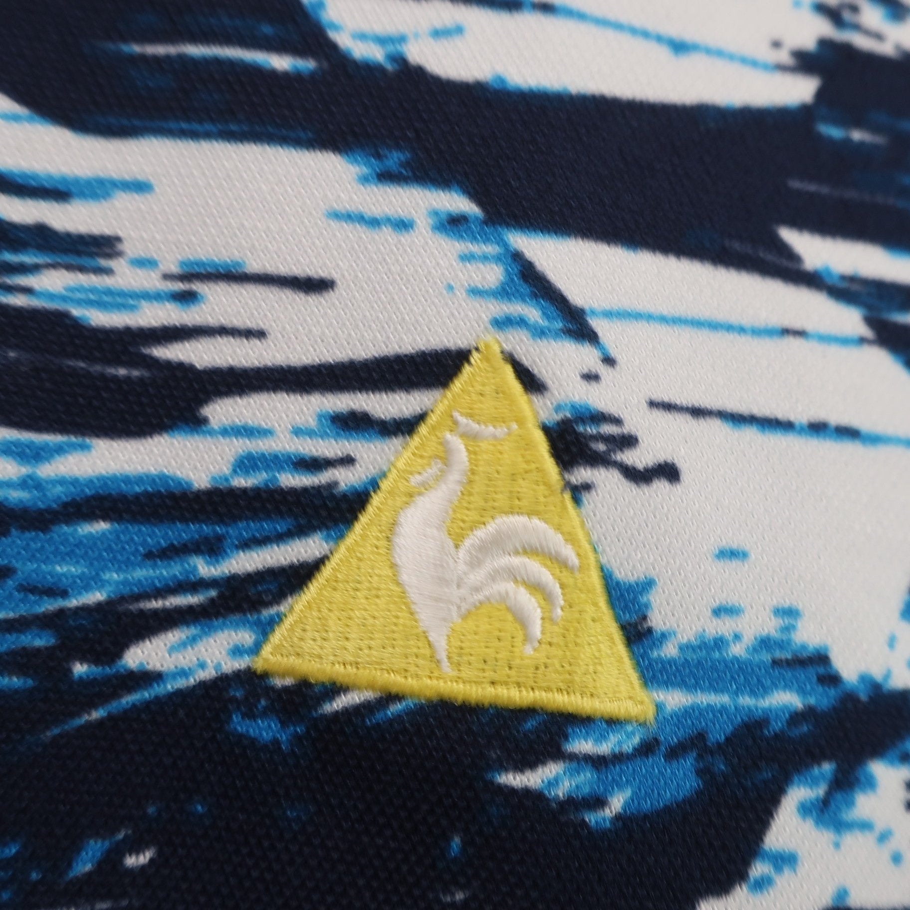 le coq sportif(ルコックスポルティフ) ポロシャツ 青系総柄 メンズ LL A