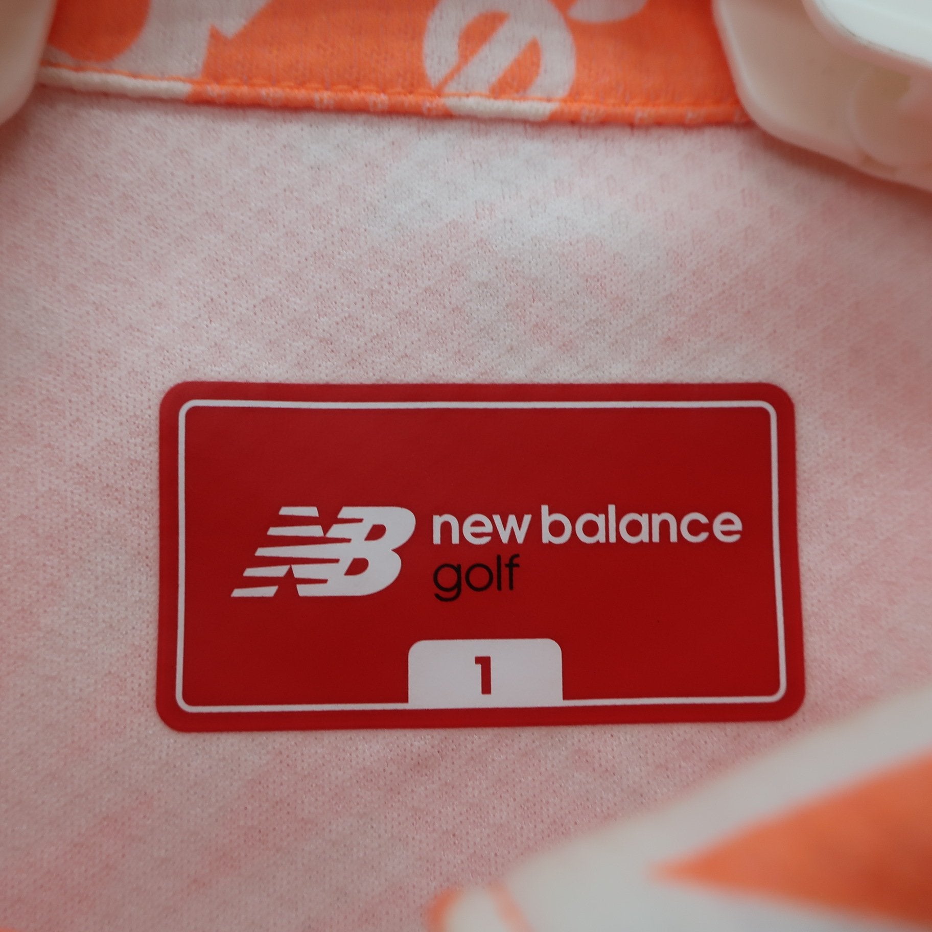 New Balance golf(ニューバランスゴルフ) ポロシャツ オレンジ白ロゴ柄 レディース 1 012-3268601 A